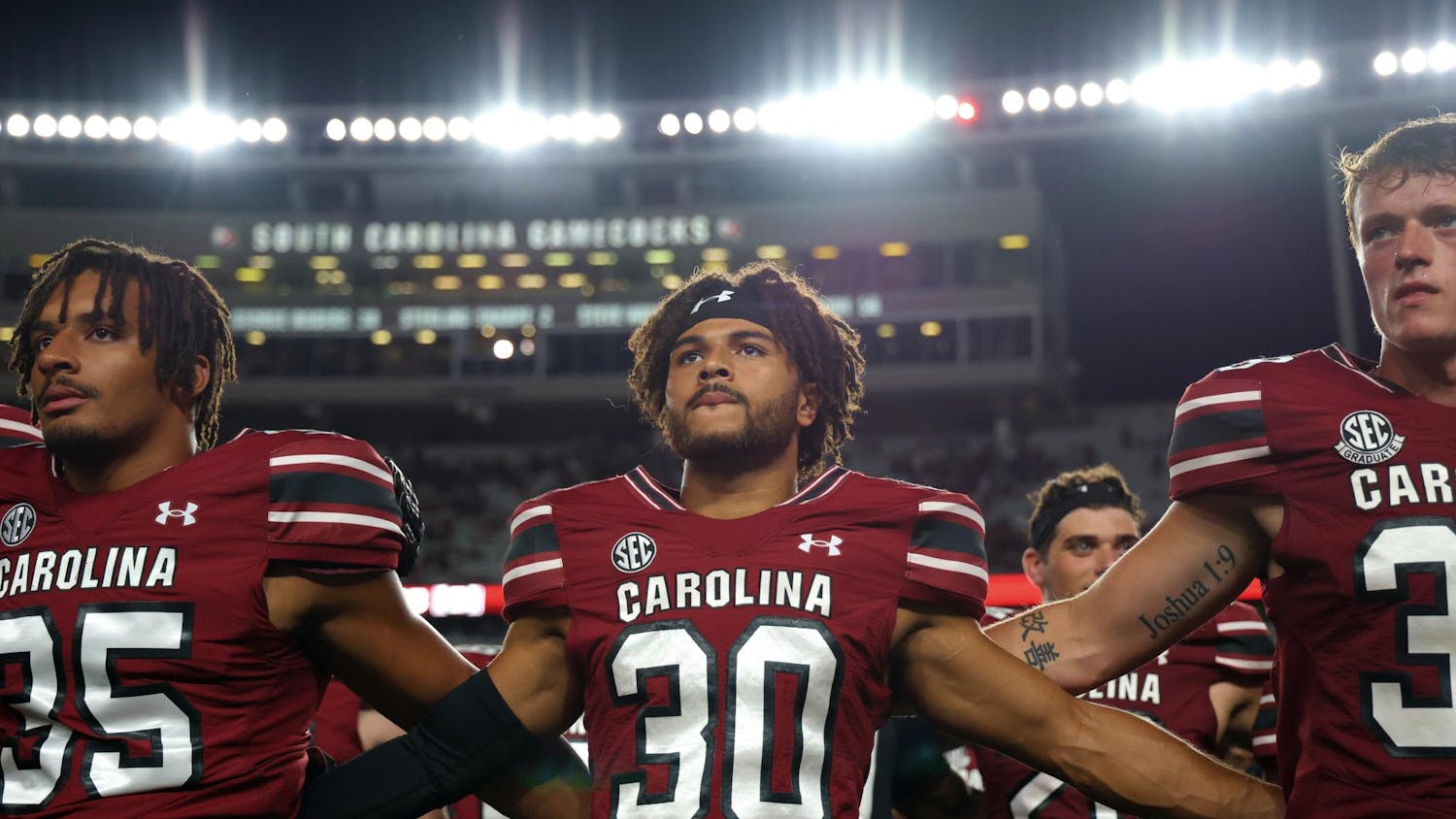 FILE — From left to right, redshirt sophomore running back Chase McCracken, redshirt sophomore defensive back Jace Blackshear, and fifth-year punter Kai Kroeger line up for the playing of the alma mater after South Carolina’s game against Old Dominion on Aug. 31, 2024. The Gamecocks defeated the Monarchs 23-19 in the teams’ first-ever matchup.