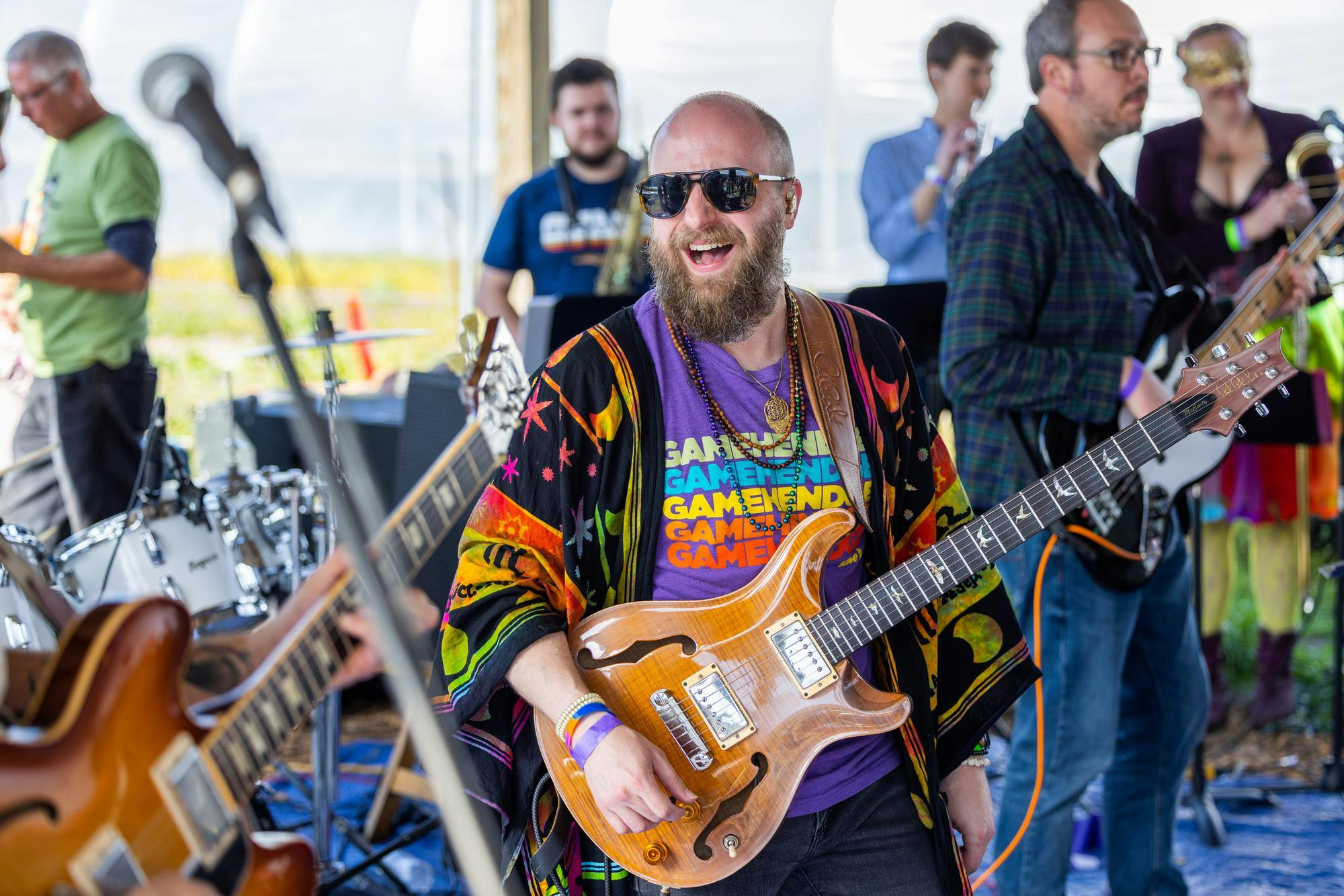 A bearded man sings at Mardi Gras in Columbia, South Carolina in 2022. The event is an annual festival celebrating the spirit of Mardi Gras and the lively community of Columbia.