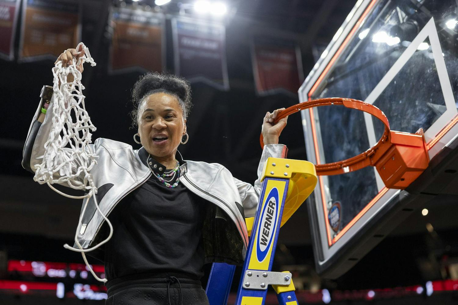 Gamecock women's basketball head coach Dawn Staley holds up the net at Rocket Mortgage FieldHouse on April 7, 2024, after making the last cut in celebration of winning the NCAA National Championship. This is Staley's third time coaching a team to the national championship.
