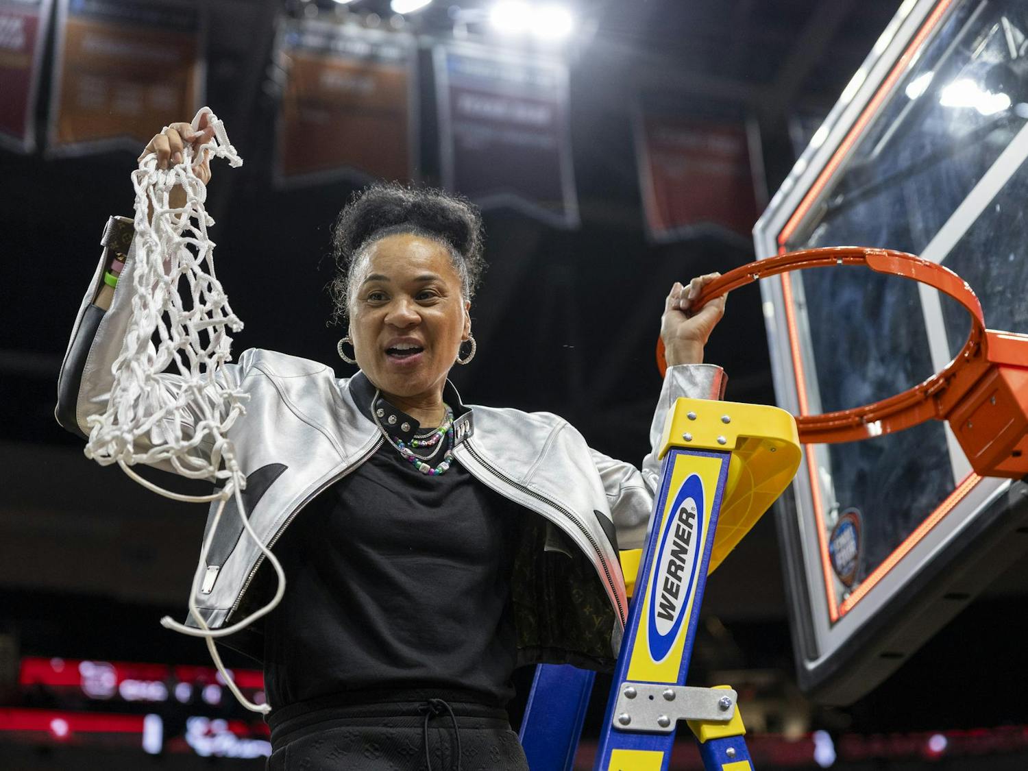 Gamecock women's basketball head coach Dawn Staley holds up the net at Rocket Mortgage FieldHouse on April 7, 2024, after making the last cut in celebration of winning the NCAA National Championship. This is Staley's third time coaching a team to the national championship.