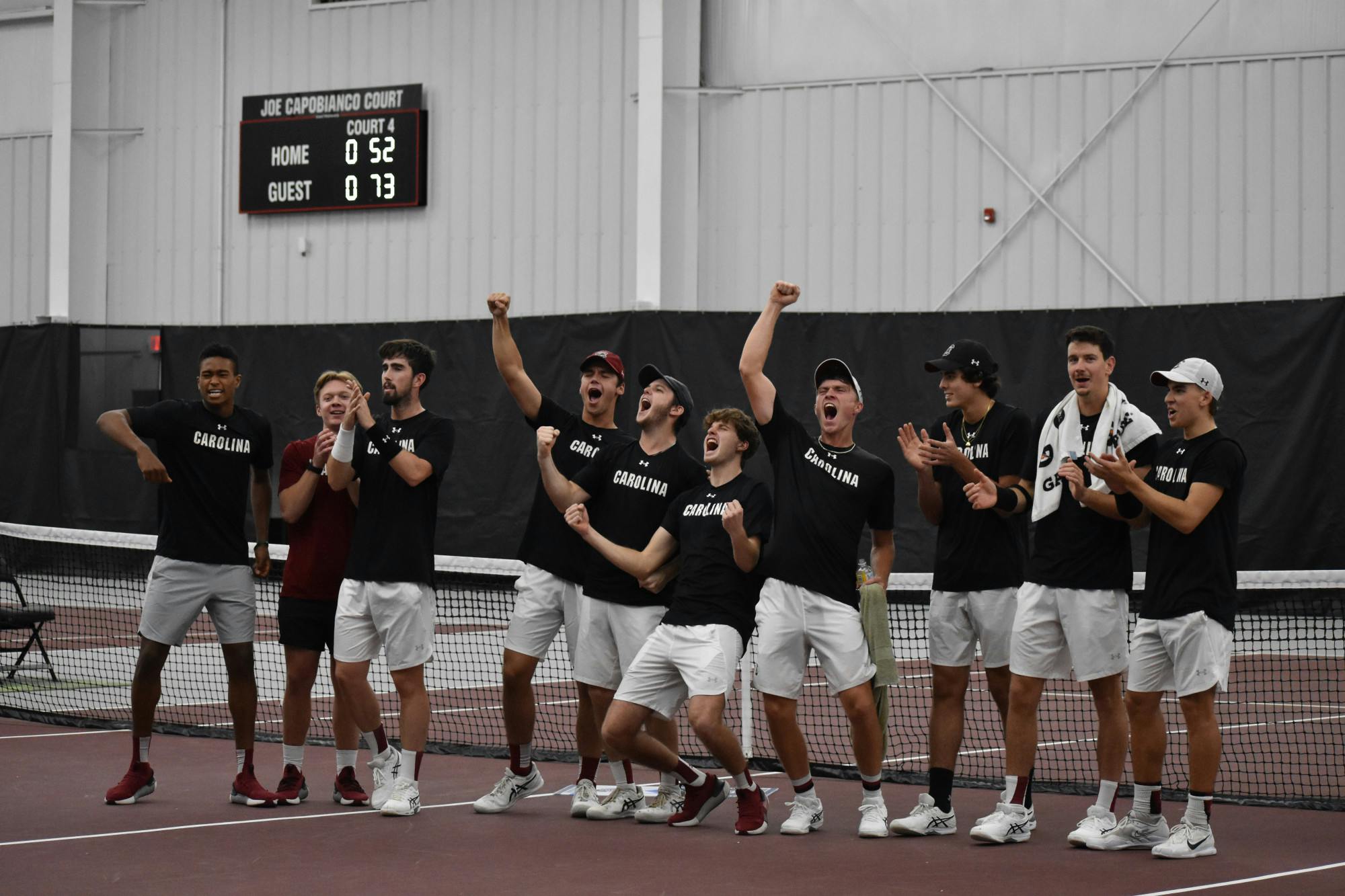 South Carolina’s men’s tennis team celebrate together after winning the ITA Kickoff Weekend event at the Carolina Indoor Tennis Center on Jan. 29, 2023. The South Carolina Gamecocks beat N.C. State 4-0.&nbsp;