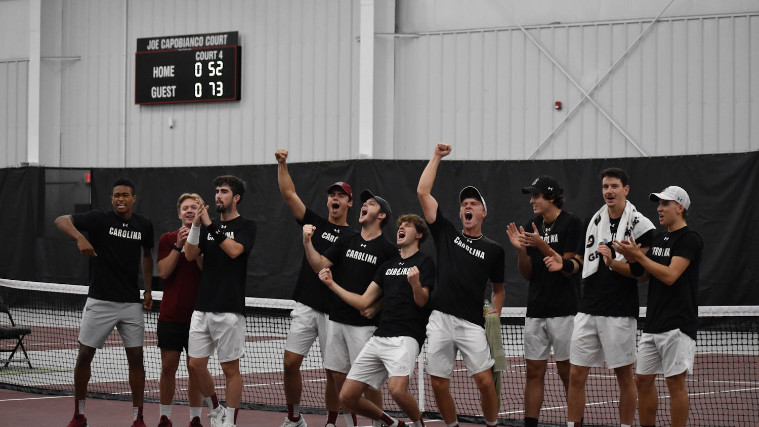 South Carolina’s men’s tennis team celebrate together after winning the ITA Kickoff Weekend event at the Carolina Indoor Tennis Center on Jan. 29, 2023. The South Carolina Gamecocks beat N.C. State 4-0.&nbsp;