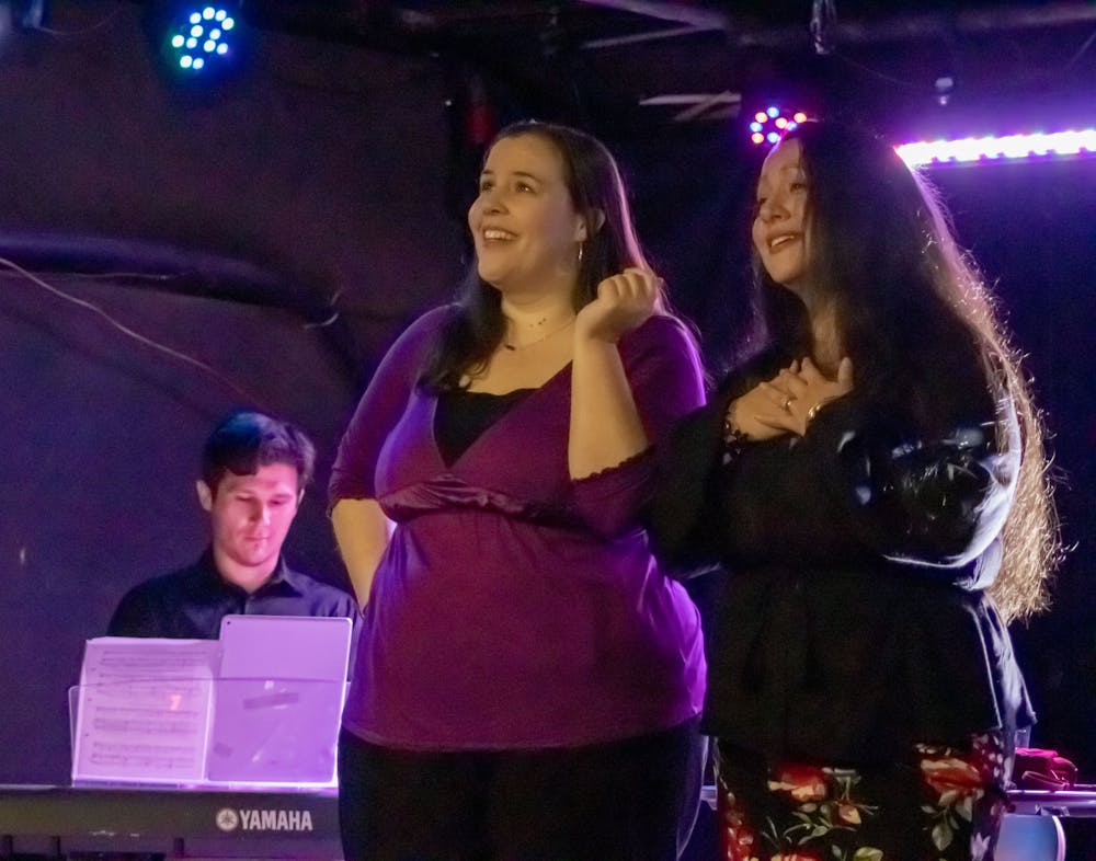 <p>Maria Beery (left) and Jennifer Mitchell (right) sing about their respective love lives during the performance of "Four Singers Walk Into A Bar" on March 26, 2023. They performed at New Brookland Tavern and various local bars in the Columbia area.</p>