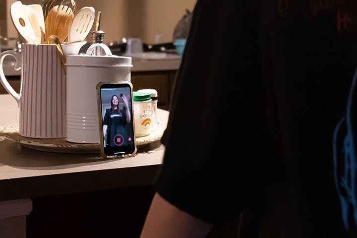 A person stands in front of their phone while doing the dance trend for the TikTok sound “Ski Mask the Slump God - Foot Fungus.”&nbsp;