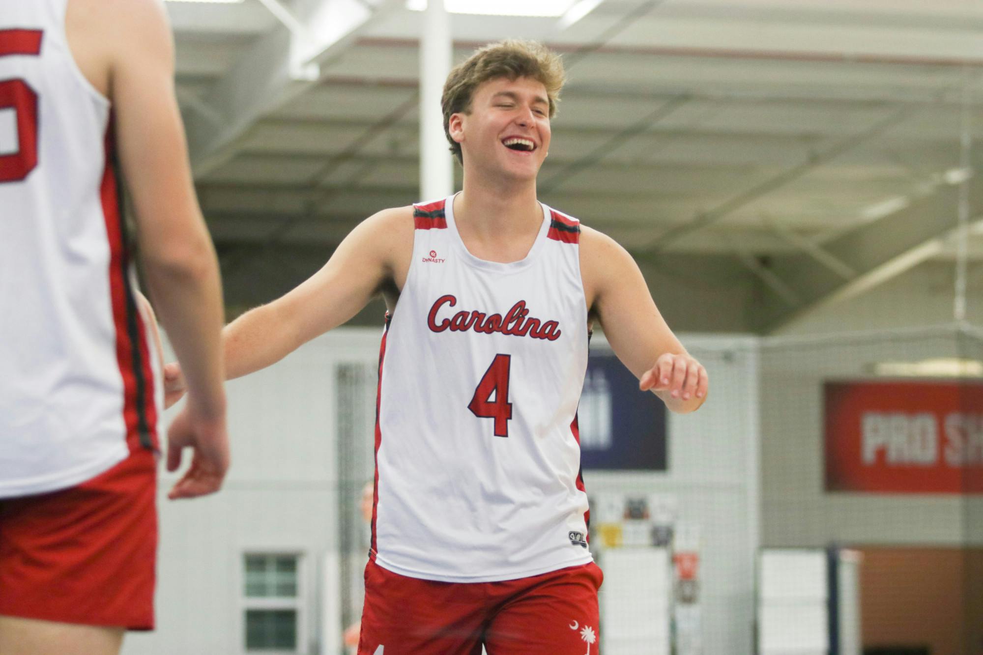 Junior outside Caden Cowart smiles in celebration of another point for the A team during their pool play. After all three Gamecock teams made it to the Gold Bracket, the A team ended up matching up against the Black team in a heated semi-finals match.&nbsp;