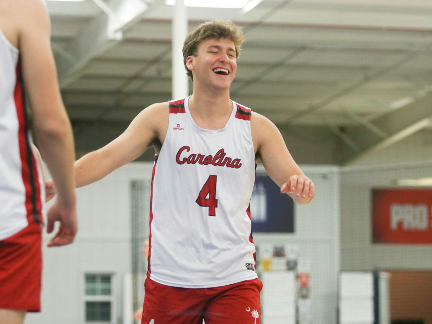 Junior outside Caden Cowart smiles in celebration of another point for the A team during their pool play. After all three Gamecock teams made it to the Gold Bracket, the A team ended up matching up against the Black team in a heated semi-finals match. 