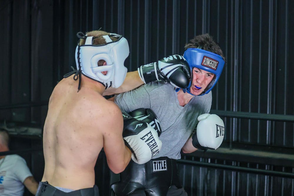 <p>First-year mechanical engineering student Noah Webber lands a punch against his opponent second-year language and international business student Luke McCarthy during a matchup against Clemson University on April 11, 2026. McCarthy defeated Webber in the three-round bout.</p>