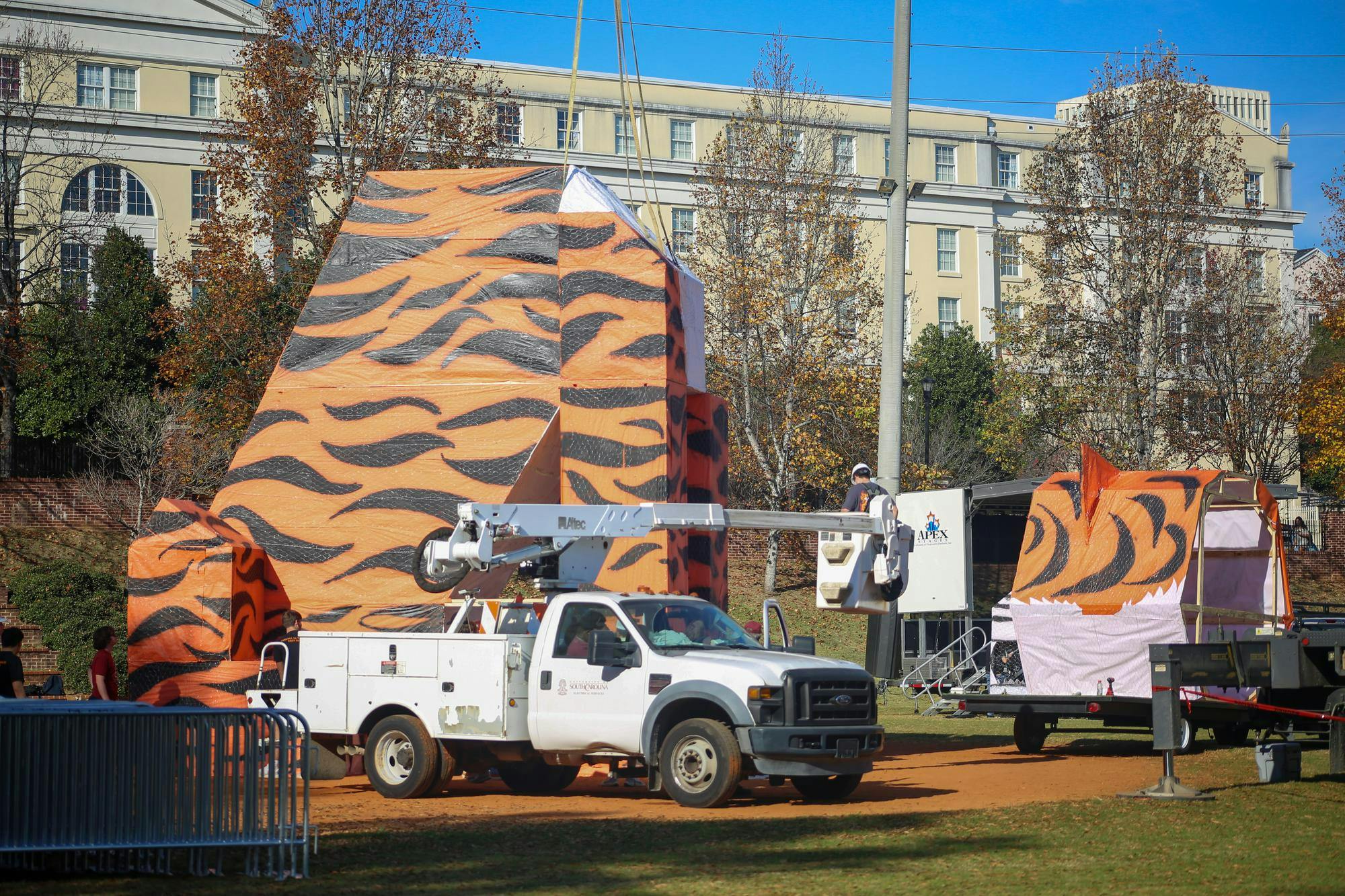 A utility truck and crane help assemble the tiger statue ahead of USC's annual Tiger Burn event at Blatt Field on Nov. 19, 2025. This year's statue reached 34 feet tall when fully assembled.
