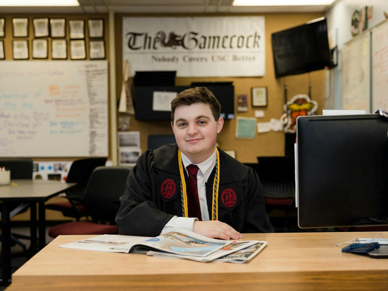 An environmental portrait of Will Kronsberg, a fourth-year broadcast journalism student, sitting at his desk in The Daily Gamecock office on Dec. 4, 2023. Kronsberg spent seven semesters working for Garnet Media Group, rising to the ranks of managing editor for The Daily Gamecock and assistant station manager for SGTV.