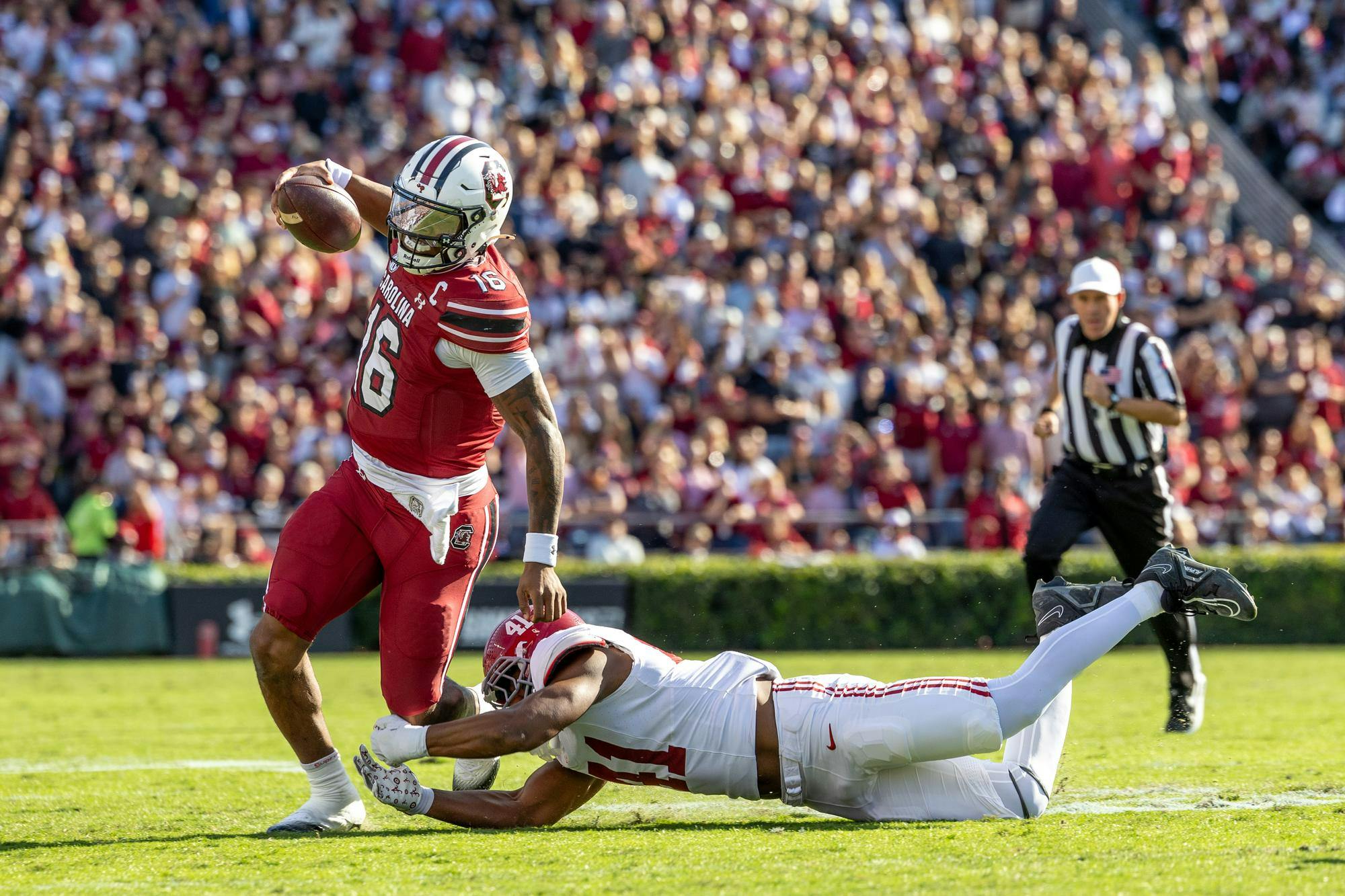 Redshirt sophomore quarterback LaNorris Sellers tries to avoid an Alabama defender while running the football on Oct. 25, 2025, at Williams-Brice Stadium. Sellers rushed for an average of 3.7 yards in the Gamecocks’ 29-22 loss to the Crimson Tide.