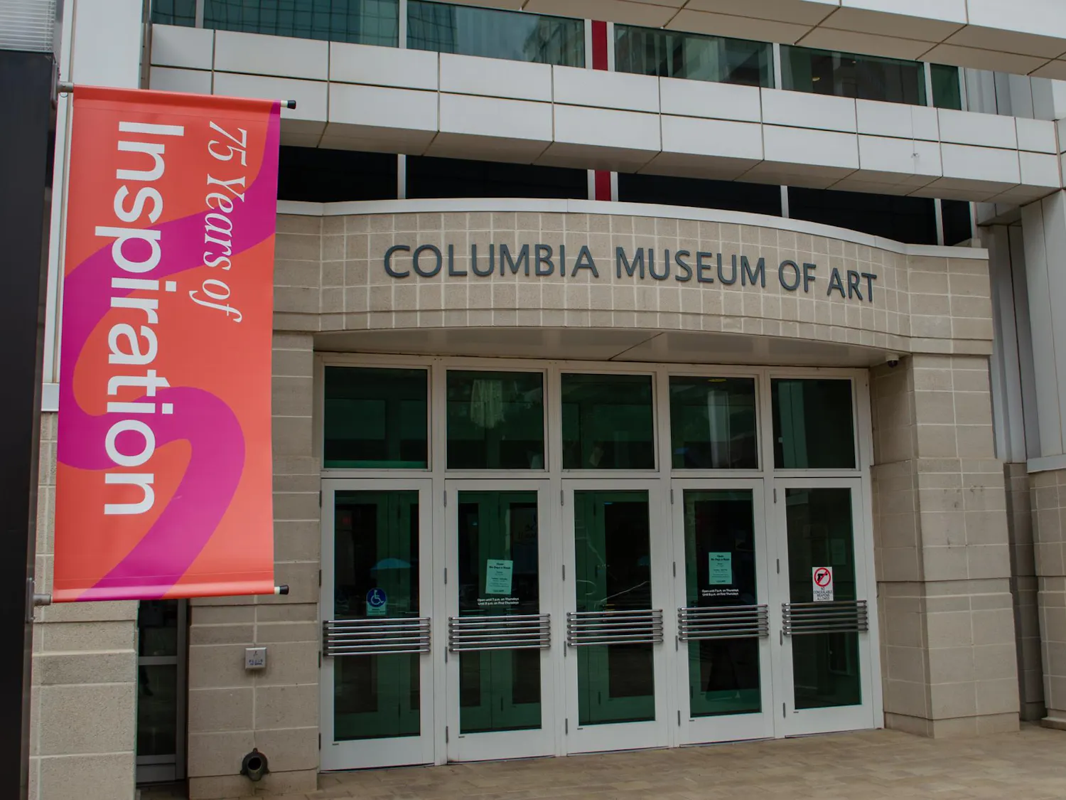 Pictured is the main entrance to the Columbia Museum of Art in Boyd Plaza at 1515 Main St., Columbia, South Carolina, on Jan. 14, 2026. A banner promotes the 75th anniversary of the museum, which coincides with the reopening of its second-floor galleries.