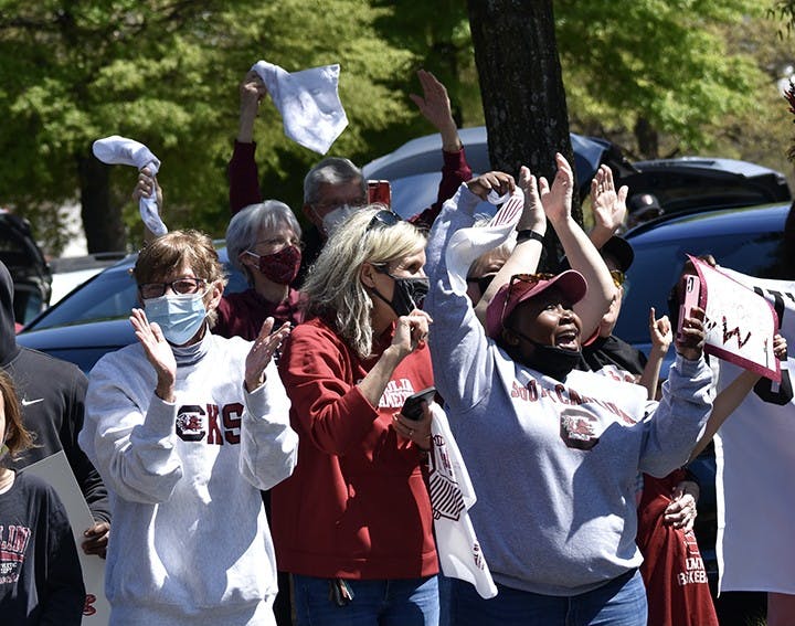Fans wave, applaud, cheer and wave rally towels to praise and celebrate the return of the USC women’s basketball team.