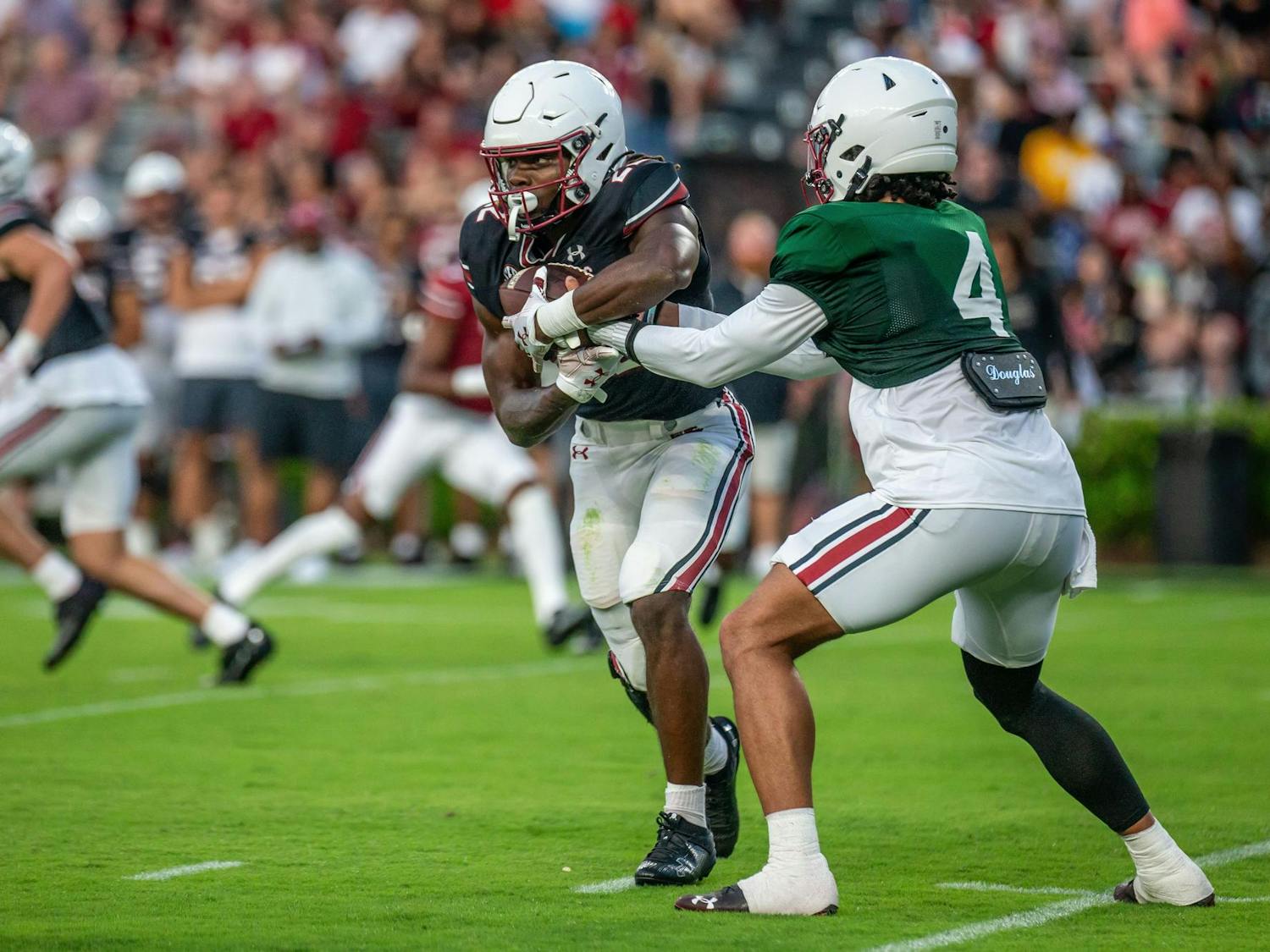Redshirt senior quarterback Robby Ashford makes the handoff to sophomore running back Jawarn Howell during the 2024 Garnet & Black Spring Game at Williams-Brice Stadium on April 20, 2024. Howell rushed for 16 yards in the Black team’s 17-0 loss to the Garnet team.