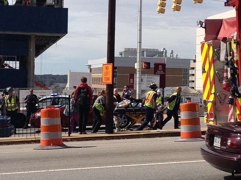 A 20-year-old woman is moved to an ambulance Tuesday afternoon after she was hit by a USC student turning left onto Assembly Street from Greene Street.