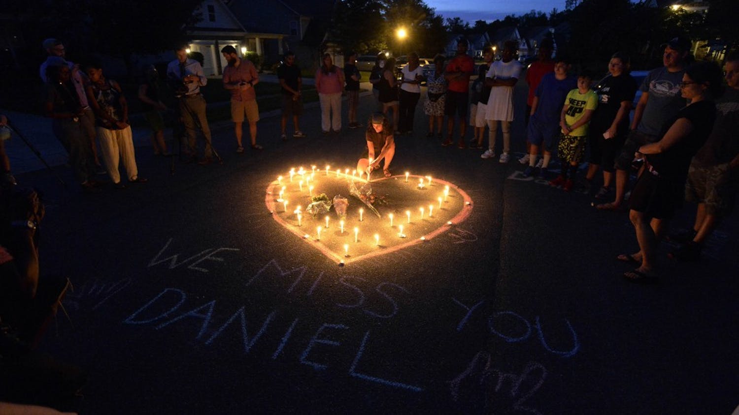 Friends and family of Daniel K. Harris gather around a heart drawn onto Seven Oaks Drive during a candlelight vigil on Monday, Aug. 22, 2016 to remember Harris, a deaf motorist who was shot and killed by a state trooper on Thursday, Aug. 18 in Charlotte, N.C. (David T. Foster III/The Charlotte Observer/TNS) 