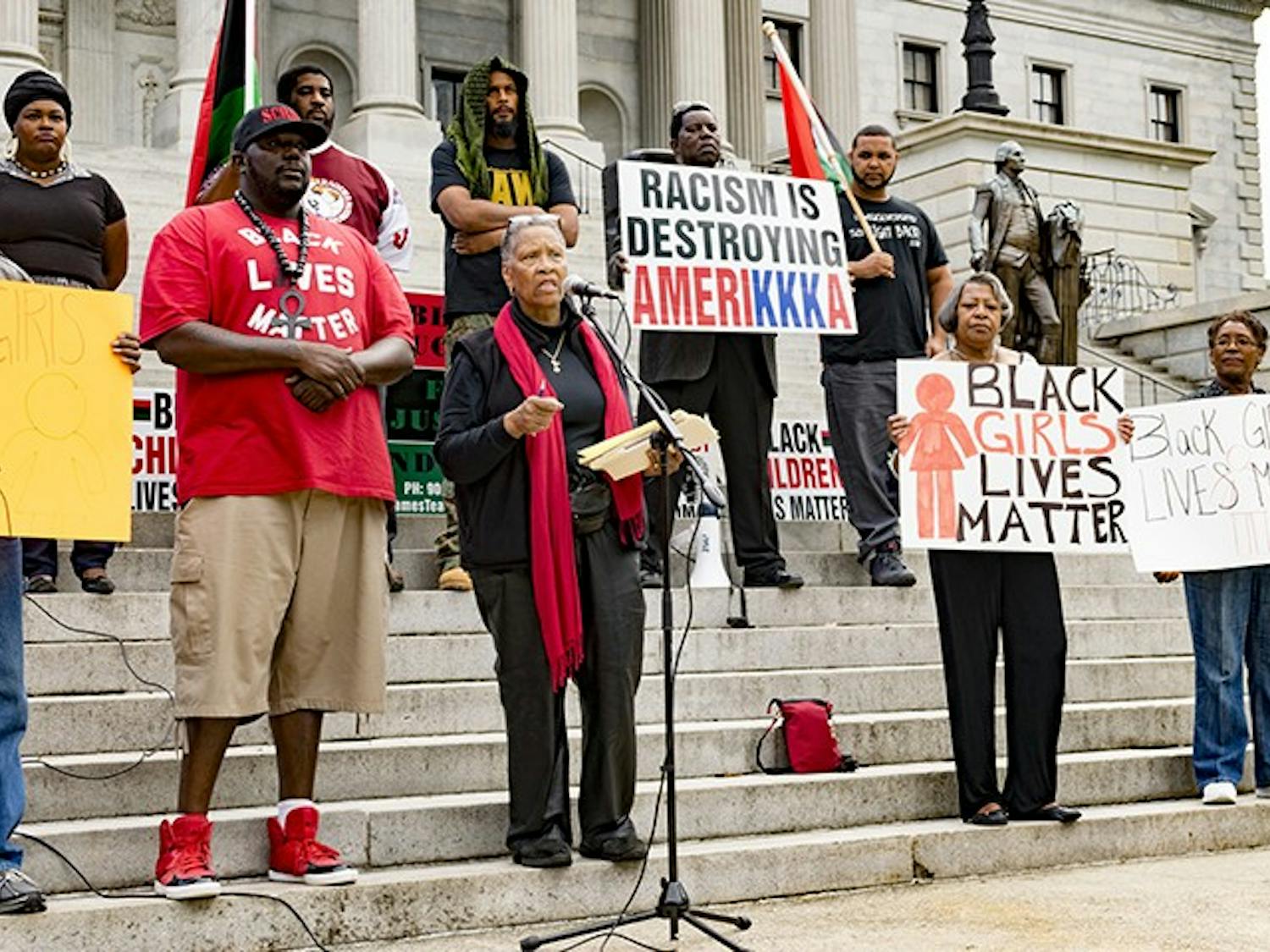 Protesters gather on the State House steps to demand change in local police departments.