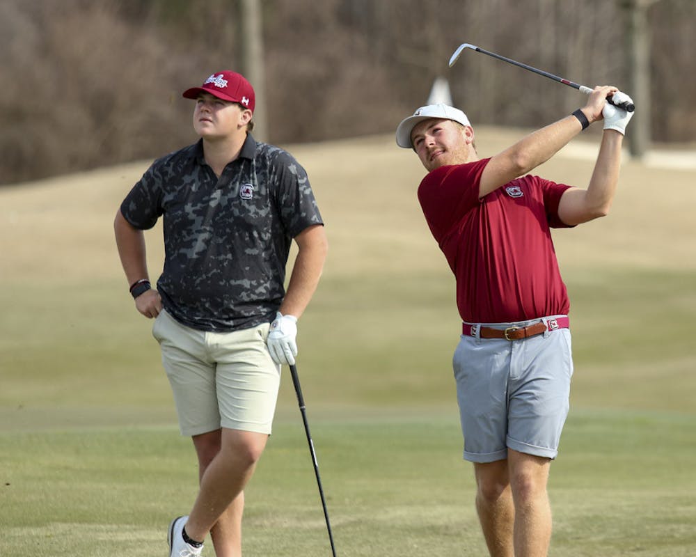 <p>Fifth-year golfer Evans Lewis (on left) and redshirt senior golfer Lansdon Robbins (on right) watch the ball after Robbins wedges it off the green during practice on Feb. 8, 2023. Robbins transferred to South Carolina from UNC Wilmington this year after placing second on the team in low strokes and being named a member of the Colonial Athletic Association Conference’s Second Team for back-to-back years in 2021 and 2022.&nbsp;</p>