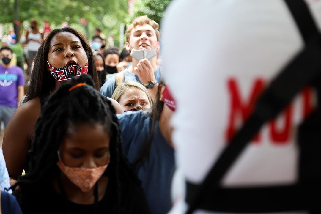 A student faces and yells at Jim Gilles while he preaches to the crowd surrounding him.