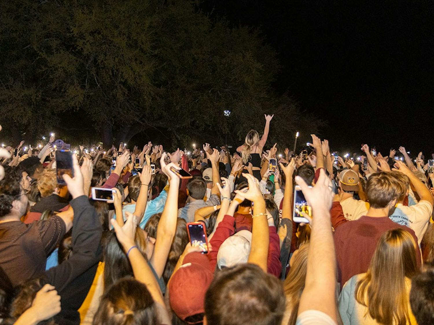 Gamecock fans on Greene Street in front of the reflection pond holding their "cups" while the alma mater plays on April 3, 2022 in Columbia, SC.&nbsp;