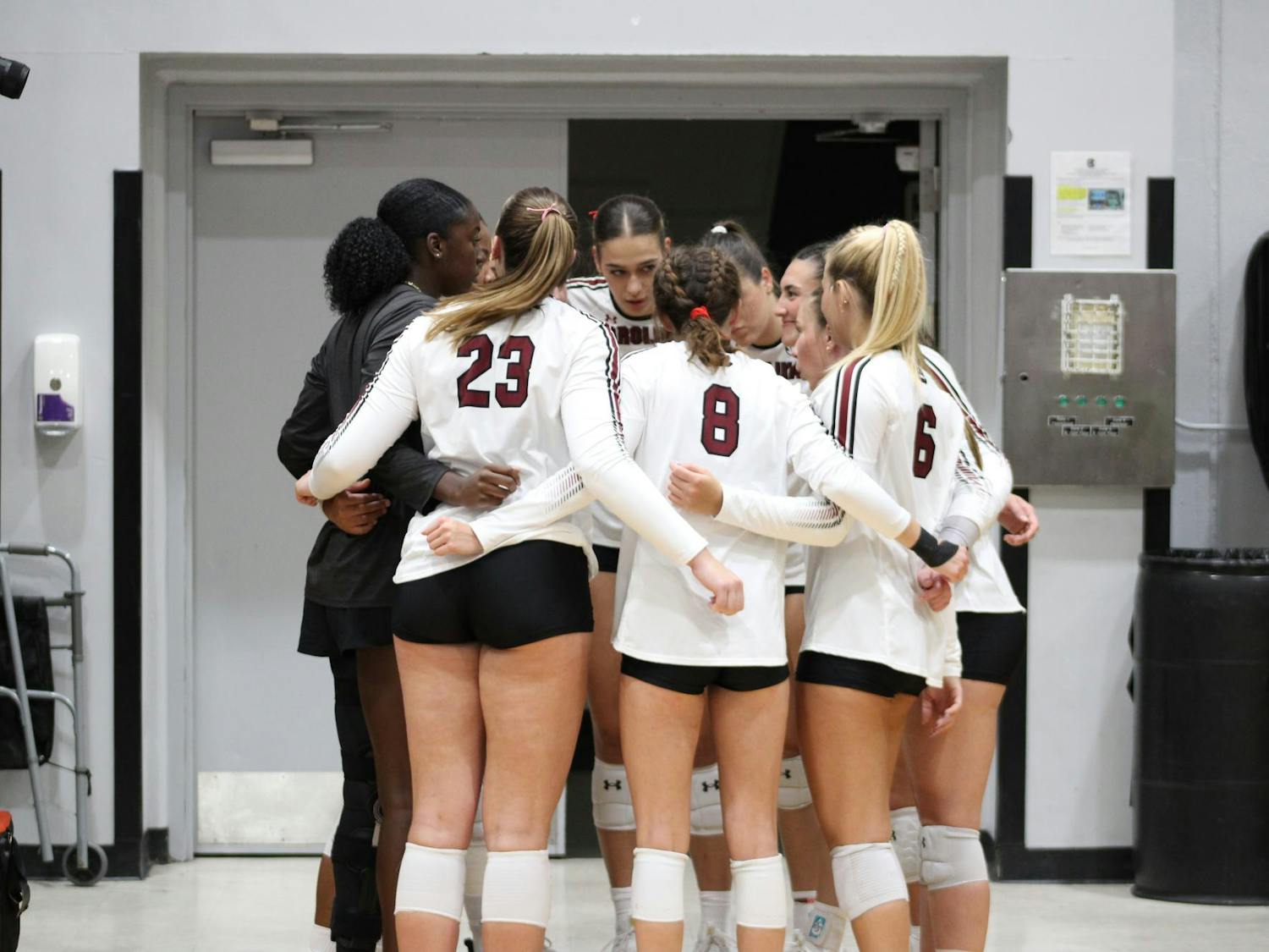 The USC women’s volleyball team circle together during a game against Texas A&M on Oct. 1, 2025, at the Carolina Volleyball Center. Moments like these represent their strong teamwork and support for each other.