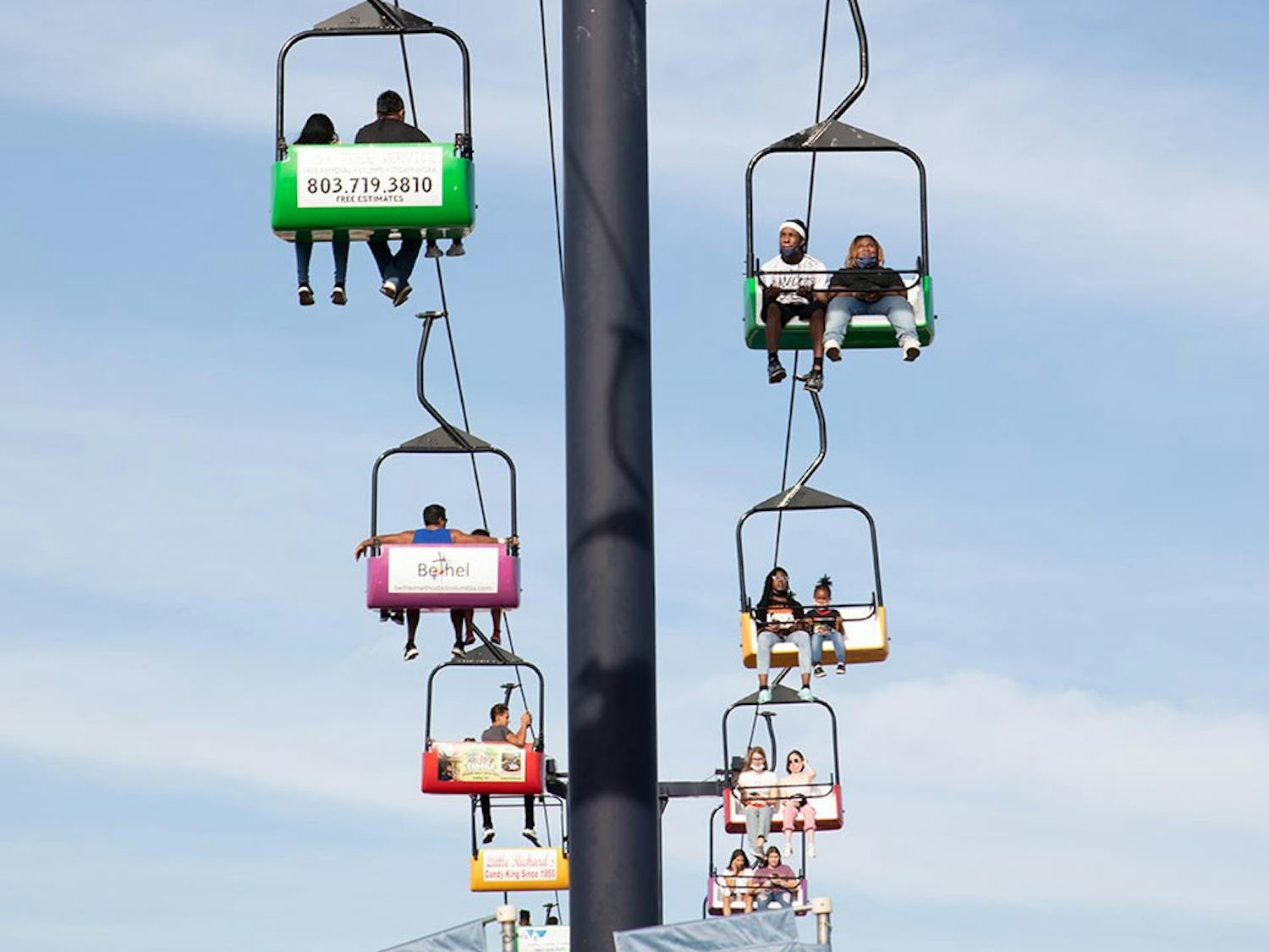 A chair lift carries fair-goers above the attractions and crowds of the annual South Carolina State Fair. 
