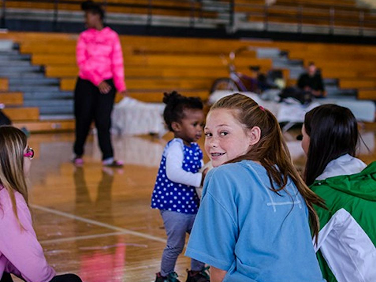 Volunteers play with children at Lower Richland High School Red Cross shelter on October 6.