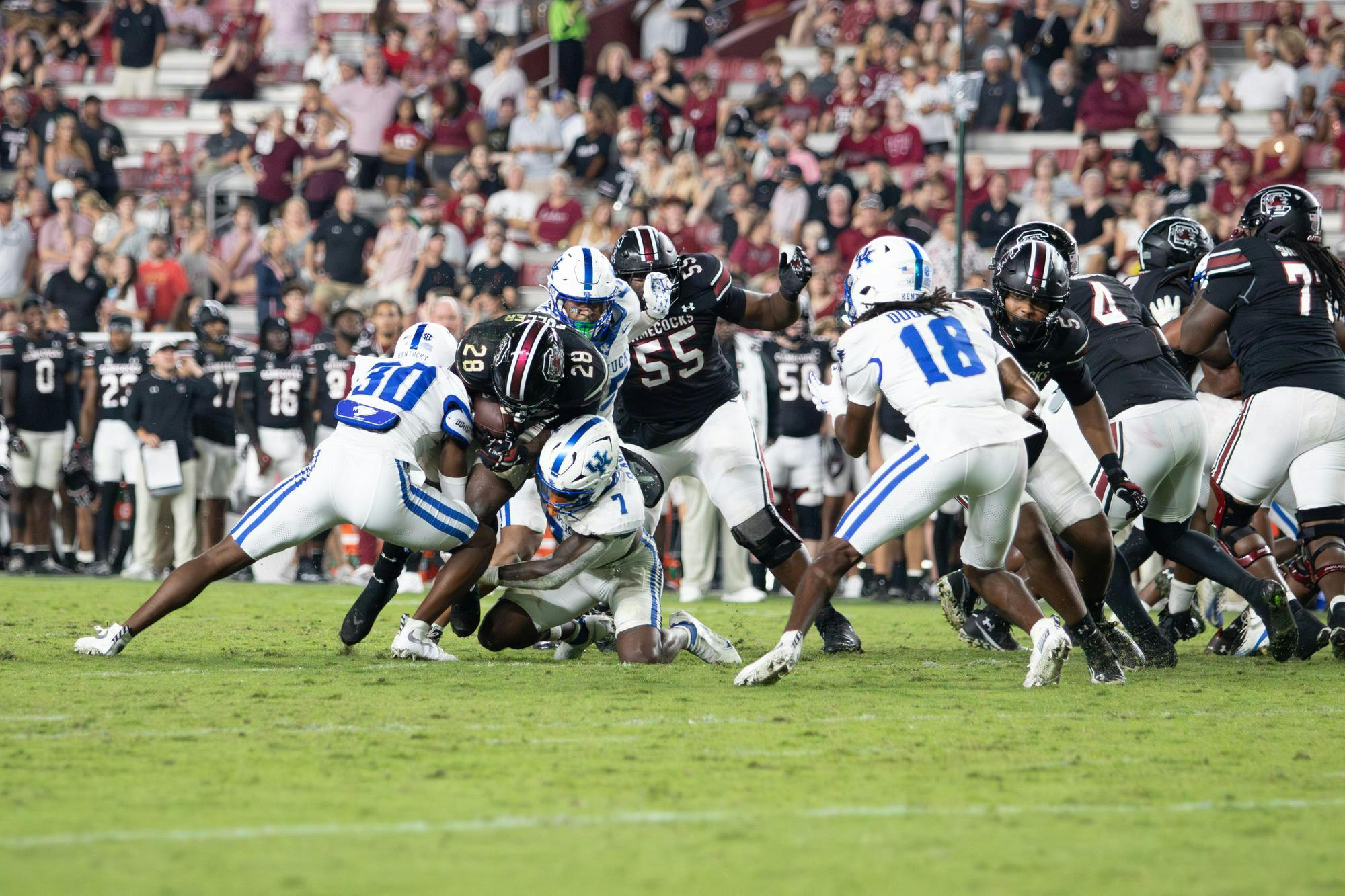 Redshirt freshman running back Matt Fuller runs over two defenders for extra yards against the University of Kentucky at Williams-Brice Stadium on Sept. 27, 2025. Fuller rushed for a total of 48 yards against the Wildcats.