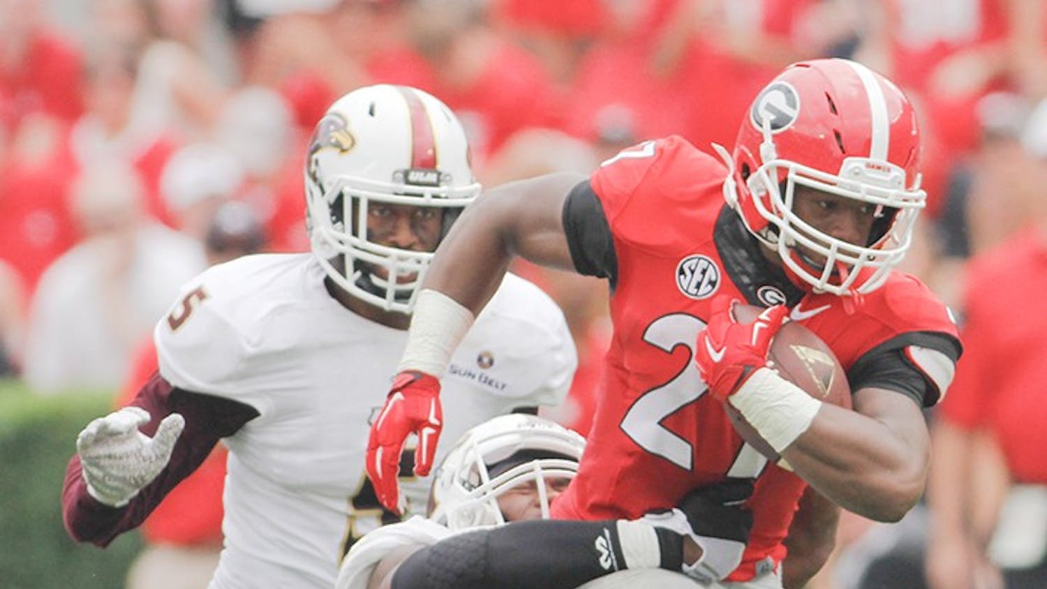 Georgia tailback Nick Chubb (27) runs the ball despite Louisiana-Monroe safety Mitch Lane (7) attempts to tackle him in the second half of an NCAA college football game against Louisiana-Monroe, on  Saturday, Sept. 5, 2015, at Sanford Stadium, in Athens, Georgia. (Photo/Taylor Carpenter)