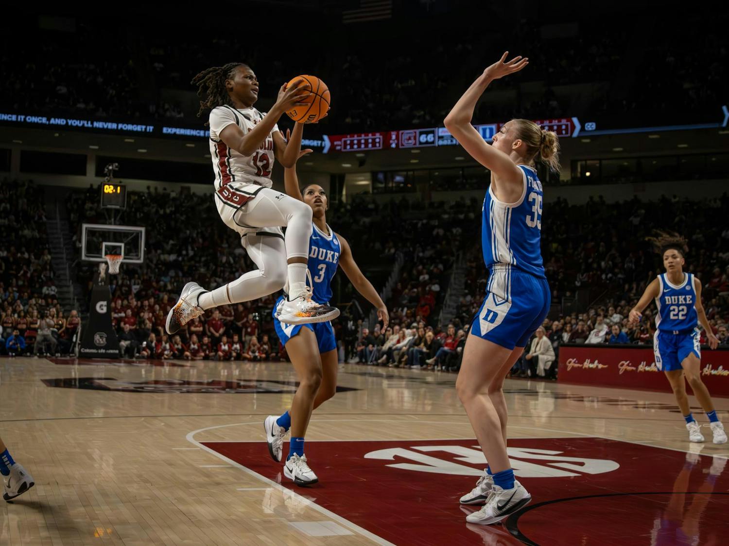 Sophomore guard MiLaysia Fulwiley attempts a layup while midair against two Duke defenders on Dec. 5, 2024. The Gamecocks defeated the Blue Devils 81-70.