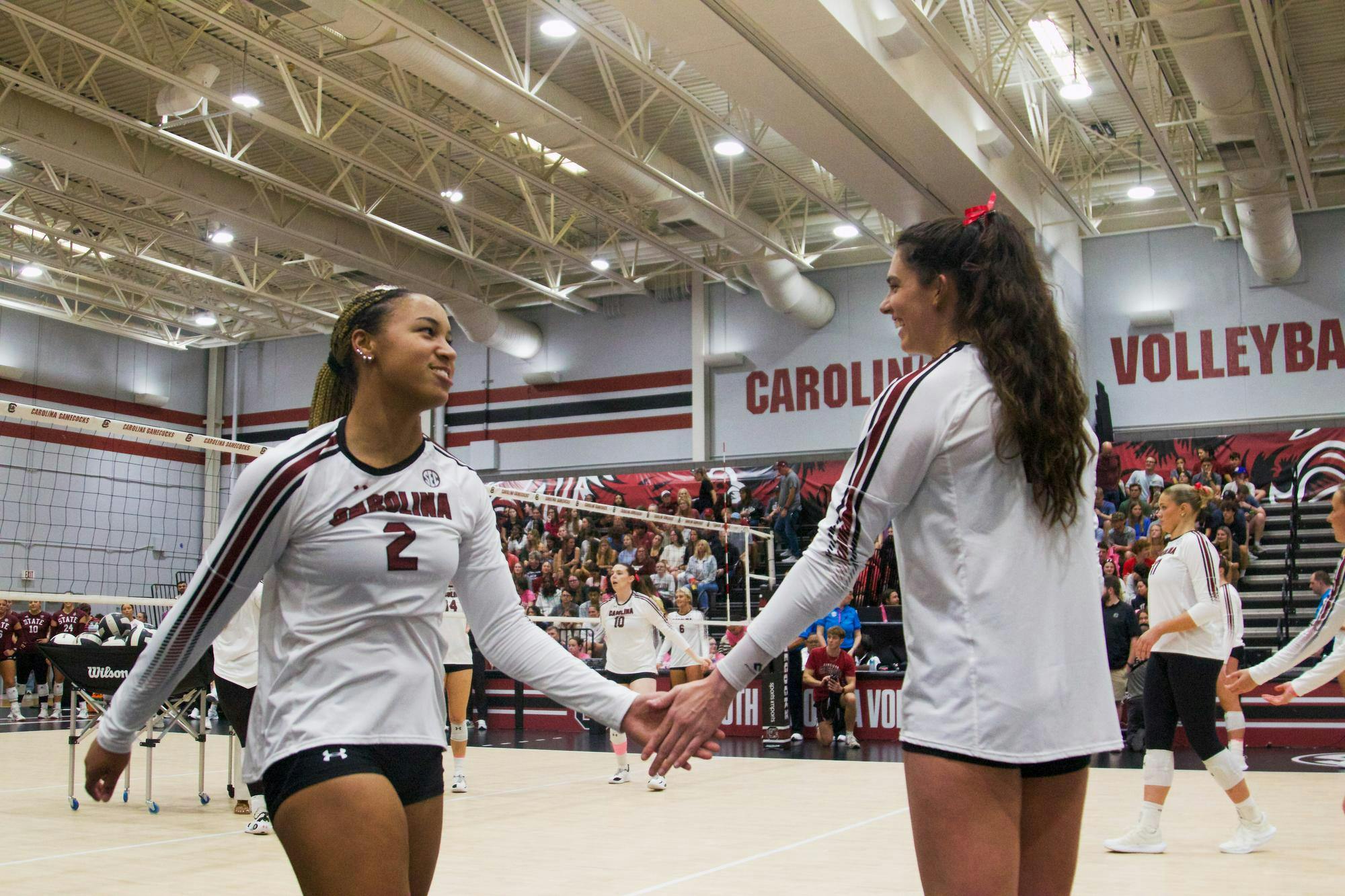 FILE — Freshman outside hitter Victoria Hill (left) and senior outside hitter Alayna Johnson (right) high-five each other during practice before the Mississippi State match on Oct. 17, 2025, at Carolina Volleyball Center. The Gamecocks are 9-13 (3-9 SEC) on the season after defeating the No. 25 Florida Gators on Nov. 2, 2025.