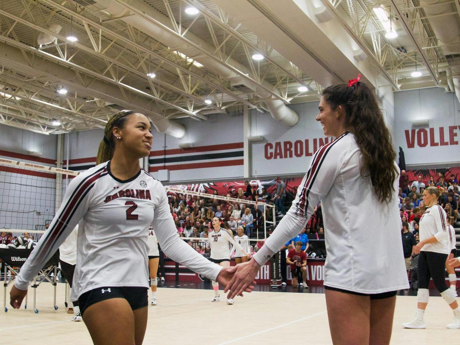 FILE — Freshman outside hitter Victoria Hill (left) and senior outside hitter Alayna Johnson (right) high-five each other during practice before the Mississippi State match on Oct. 17, 2025, at Carolina Volleyball Center. The Gamecocks are 9-13 (3-9 SEC) on the season after defeating the No. 25 Florida Gators on Nov. 2, 2025.