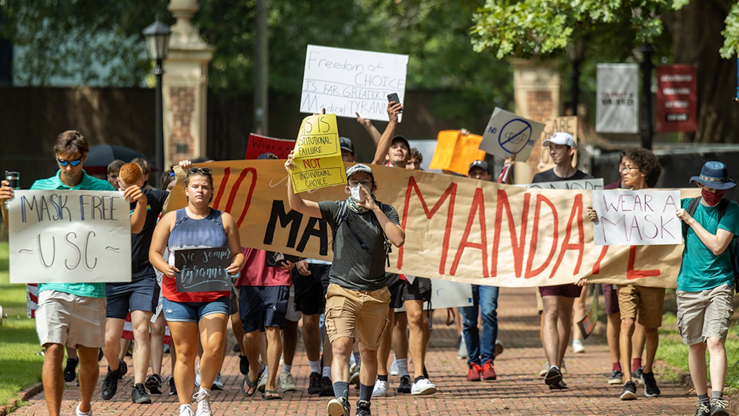 The USC Turning Point USA chapter protests on the Horseshoe over the mask mandate while the Carolina Socialists counterprotest. The mask mandate was put in place by interim university President Harris Pastides on Aug. 18, 2021.