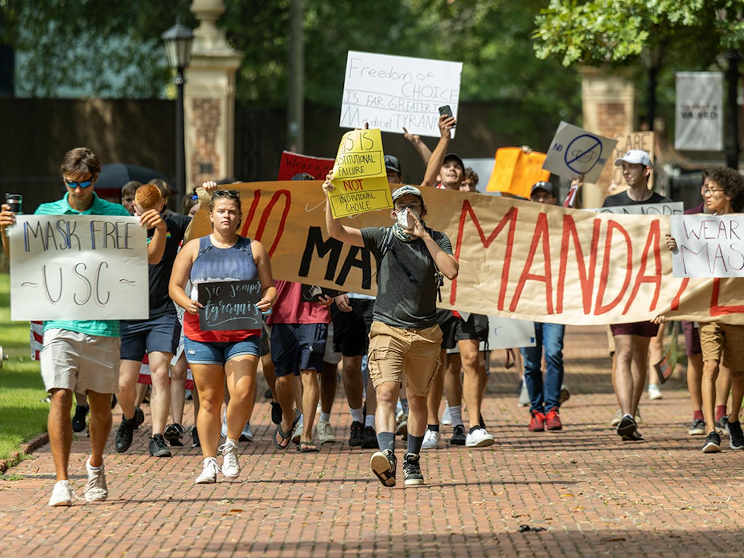 The USC Turning Point USA chapter protests on the Horseshoe over the mask mandate while the Carolina Socialists counterprotest. The mask mandate was put in place by interim university President Harris Pastides on Aug. 18, 2021.