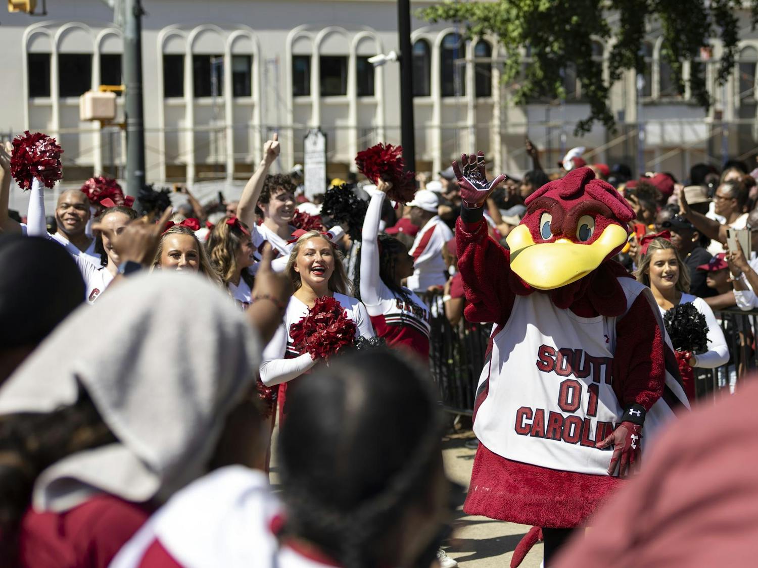 Cocky and South Carolina cheerleaders walk in the national championship parade down Main Street on April 14, 2024. Cheerleaders, Cocky, the Carolina Coquettes and the Carolina Band were a portion of the population present at the parade.