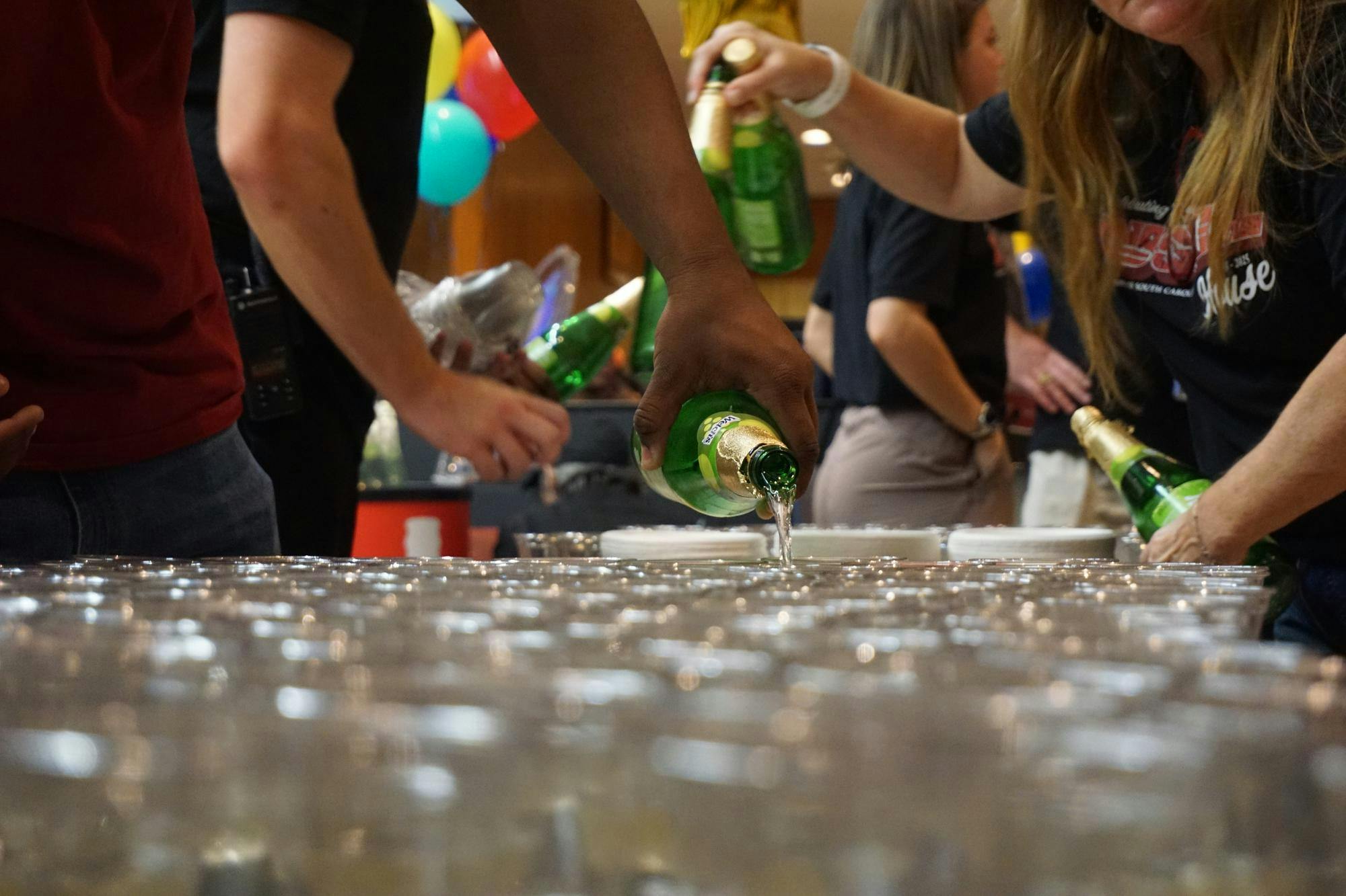 Bustle at the Russell staff poured drinks out for students to take on Oct. 16, 2025, in the Russell House. Students and staff celebrated Russell House turning 70 throughout the night with activities such as roller-skating, a cake cutting done by USC President Amiridis and interactive entertainment.