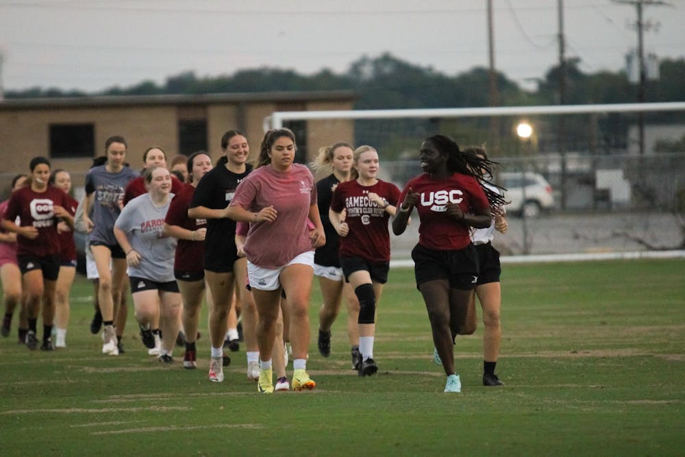 <p>The University of South Carolina’s Women's Club Rugby team warms up for their practice at 1101 Bluff Road on Sept. 30, 2024. President Parks Elkins oversees running the drills at the beginning of practice.</p>