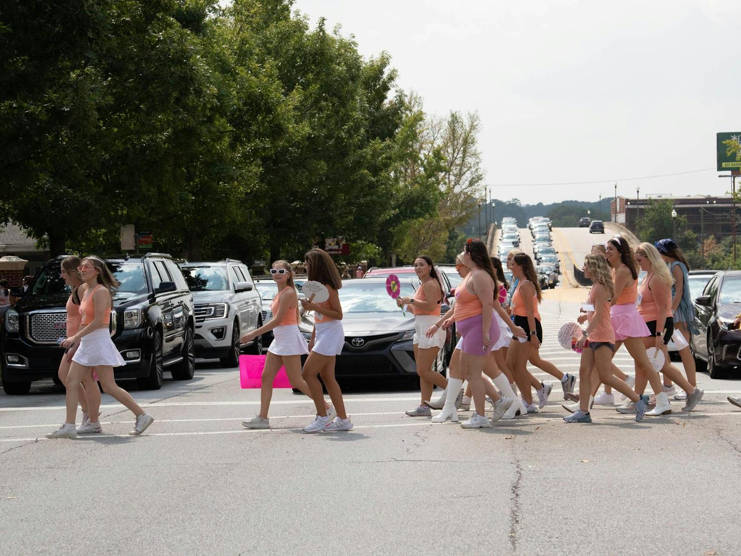 Cars stop on Blossom Street as sorority members return to Greek Village on Aug, 27, 2023. More than 2,100 potential new members participated in recruitment this fall.