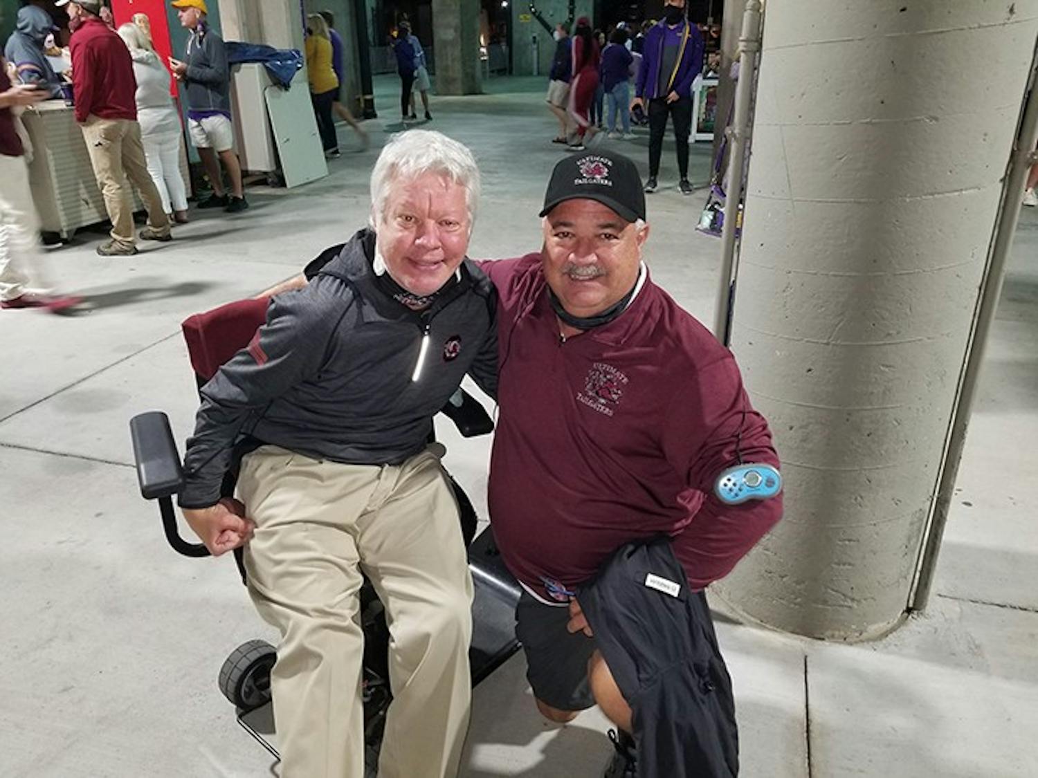 Kirk Hollingsworth (left) and Chris Fulmer (right) take a picture together at a Gamecock football game. The duo have been attending games religiously since they were kids.