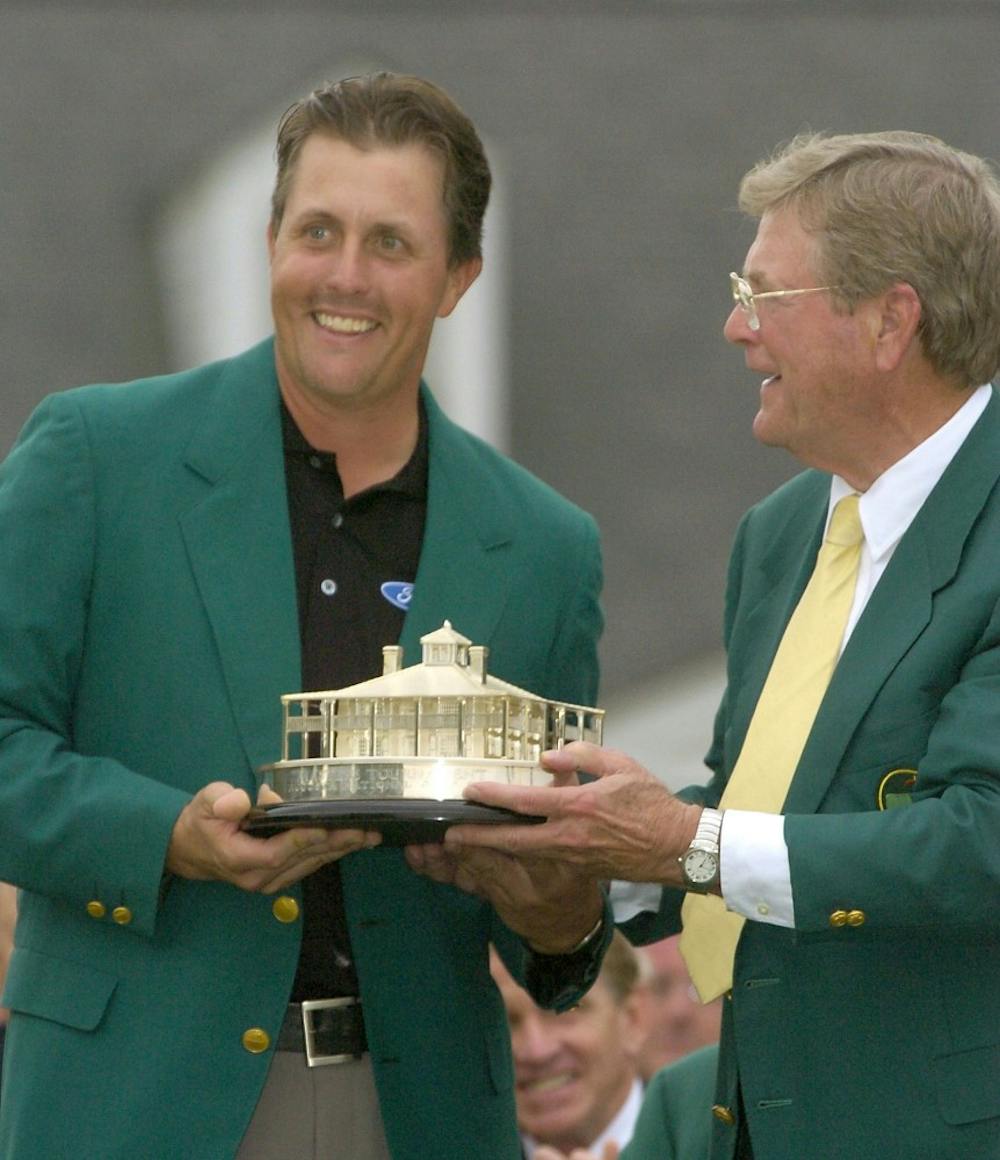KRT SPORTS STORY SLUGGED: GLF-MASTERS KRT PHOTOGRAPH BY ERIK CAMPOS/THE STATE (April 11) AUGUSTA, GA -- Phil Mickelson is presented the Masters trophy from the Augusta National president Hootie Johnson after winning the U.S. Masters golf tournament with a birdie on the 18th hole at the Augusta National Golf Club in Augusta, Georgia, Sunday, April 11, 2004. This was Mickelson's first major tournament win. (nk) 2004