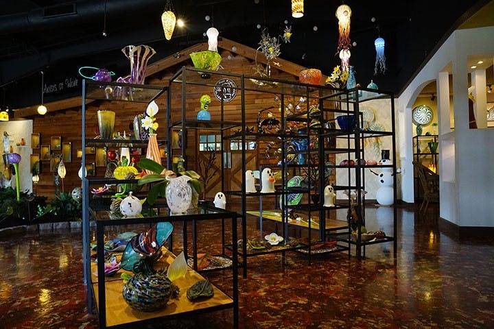 Many different pieces of glass art sit on display at One Eared Cow. The art includes ghosts, bats and zombies to fit the Halloween holiday.