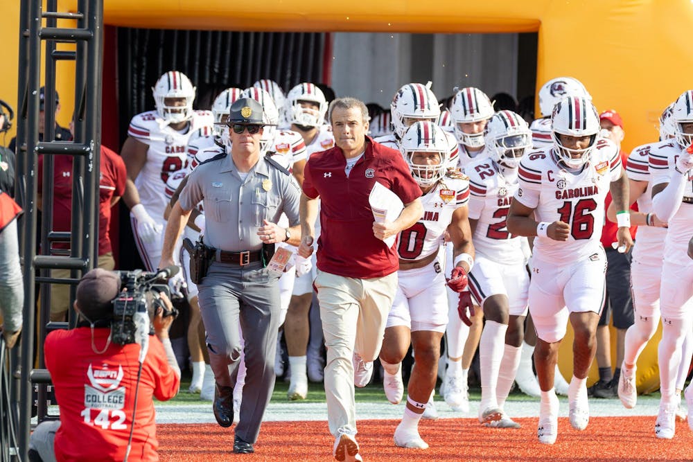 <p>FILE – Football head coach Shane Beamer runs out of South Carolina's tunnel with the rest of the team at the beginning of the Cheez-It Citrus Bowl on Dec. 31, 2024 at Camping World Stadium. Beamer has signed multiple top recruits and transfer portal players in preparation for next year's season.</p>