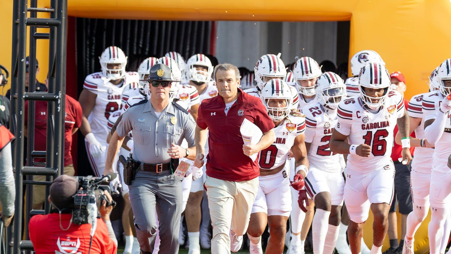 FILE – Football head coach Shane Beamer runs out of South Carolina's tunnel with the rest of the team at the beginning of the Cheez-It Citrus Bowl on Dec. 31, 2024 at Camping World Stadium. Beamer has signed multiple top recruits and transfer portal players in preparation for next year's season.