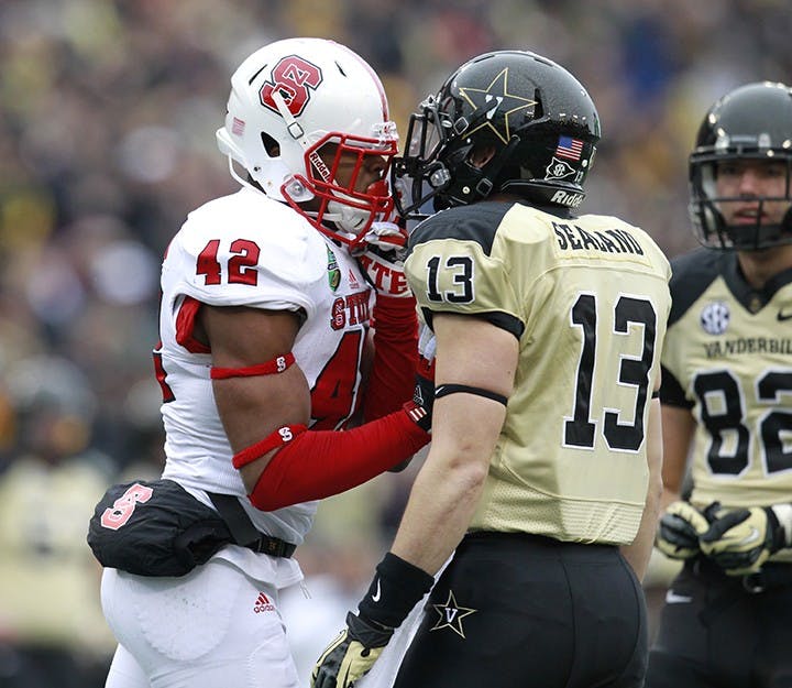 N.C. State&apos;s M.J. Salahuddin (42) has words with Vanderbilt&apos;s Jake Sealand (13) during the first half of the Franklin American Mortgage Music City Bowl at LP Field in Nashville, Tennessee, Monday, December 31, 2012. The Vanderbilt Commodores defeated the N.C. State Wolfpack, 38-24. (Ethan Hyman/Raleigh News &amp; Observer/MCT)