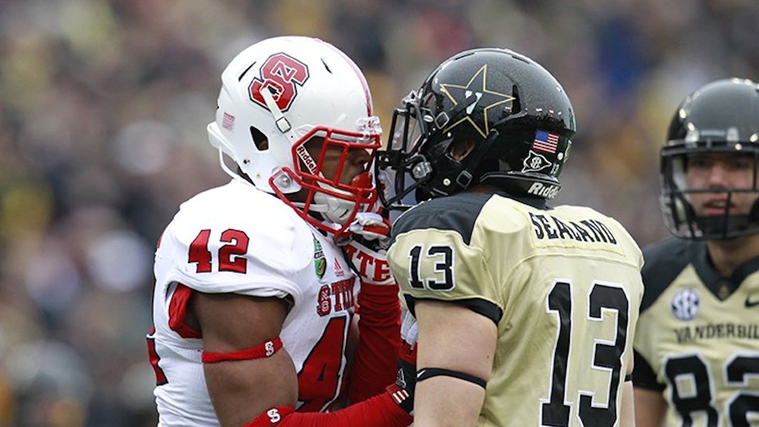 N.C. State&apos;s M.J. Salahuddin (42) has words with Vanderbilt&apos;s Jake Sealand (13) during the first half of the Franklin American Mortgage Music City Bowl at LP Field in Nashville, Tennessee, Monday, December 31, 2012. The Vanderbilt Commodores defeated the N.C. State Wolfpack, 38-24. (Ethan Hyman/Raleigh News &amp; Observer/MCT)