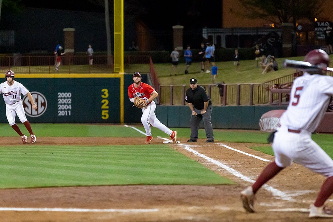 Ole Miss Senior Time Elko (in middle) runs into position before the pitch is thrown to Freshman utility player Talmadge Lecroy (on right). The Rebels beat the South Carolina Gamecocks 9-1.