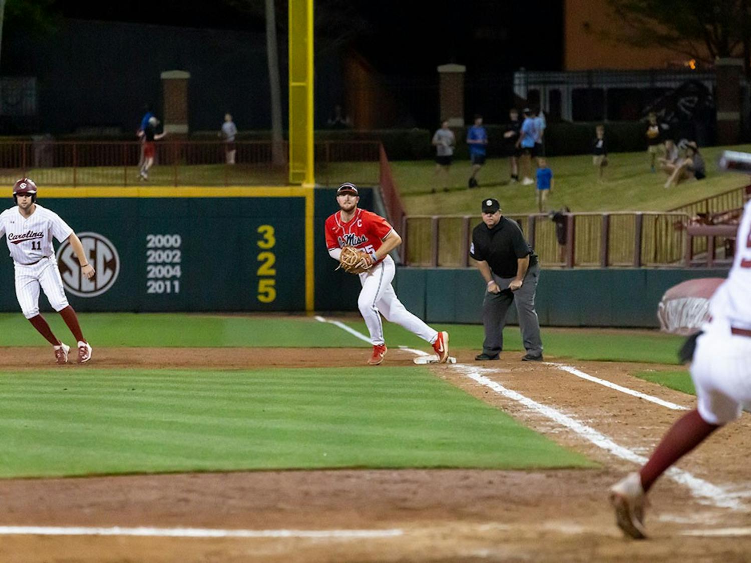 Ole Miss Senior Time Elko (in middle) runs into position before the pitch is thrown to Freshman utility player Talmadge Lecroy (on right). The Rebels beat the South Carolina Gamecocks 9-1.
