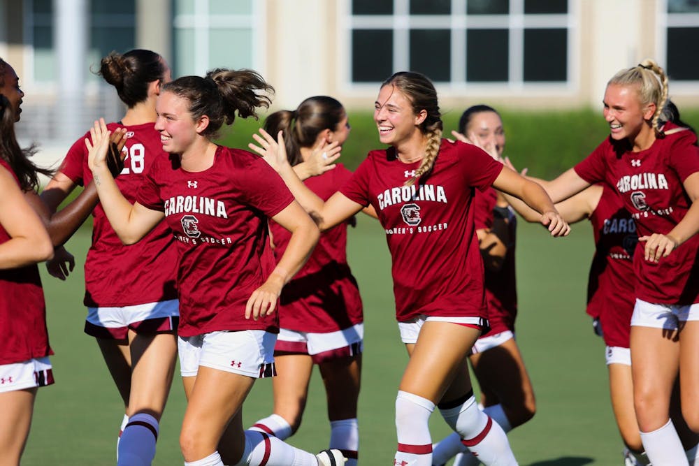 <p>Senior midfielder Brianna Behm (left), freshman defender Amanda Patrick (middle) and freshman defender Sophie Johnson (right) high-five other members of the Gamecock women's soccer team prior to their game on Sept. 3, 2023. The team is ranked No. 16 in the country and will host the first round of the NCAA tournament on Nov. 10, 2023.</p>