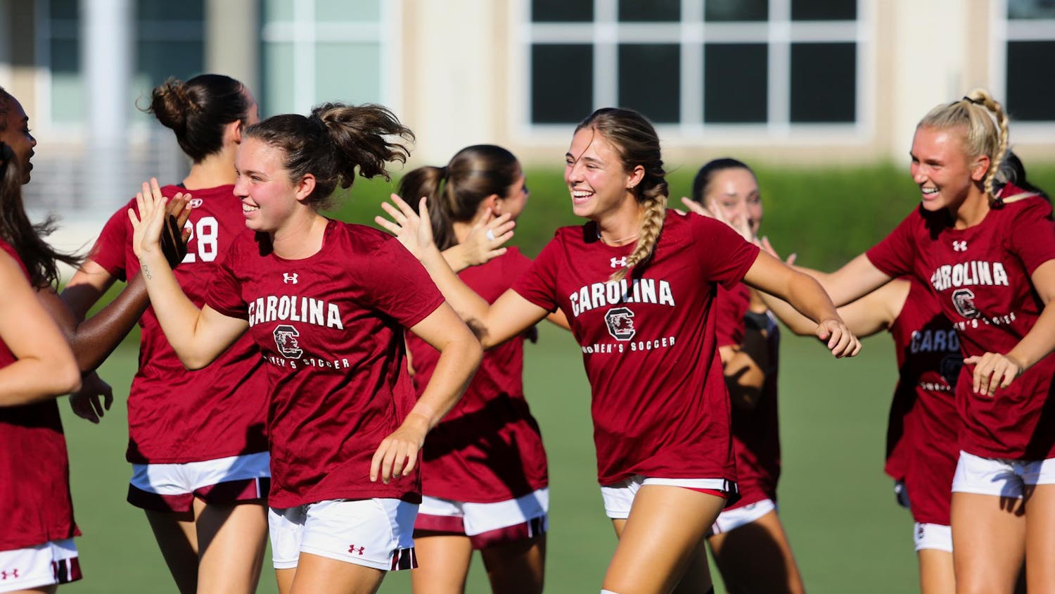 Senior midfielder Brianna Behm (left), freshman defender Amanda Patrick (middle) and freshman defender Sophie Johnson (right) high-five other members of the Gamecock women's soccer team prior to their game on Sept. 3, 2023. The team is ranked No. 16 in the country and will host the first round of the NCAA tournament on Nov. 10, 2023.