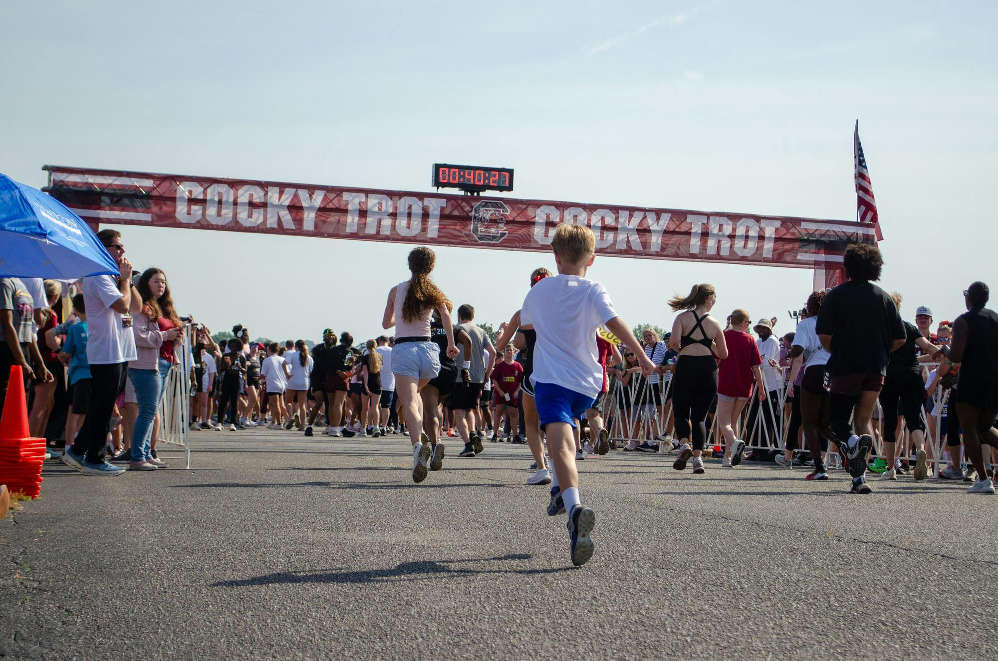 Two children sprint to the finish line of the fifth annual Cocky Trot 5K at the South Carolina State Fairgrounds on April 25, 2026. The race featured participants of all ages, from elderly people to babies pushed in strollers.