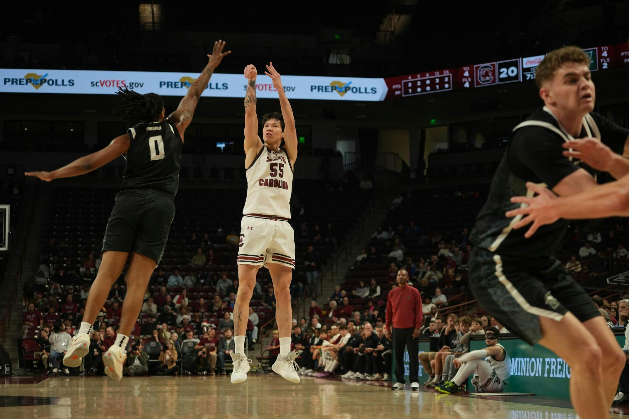 South Carolina pushes offense as senior guard Mike Sharavjamts elevates for a jumper while Stetson defenders scramble to close out. The scene occurred inside Colonial Life Arena in Columbia, South Carolina.